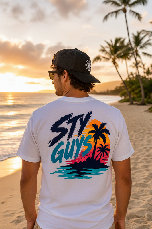 Man on the beach wearing the StyGuys Endless Summer tee with neon sunset palms back print
