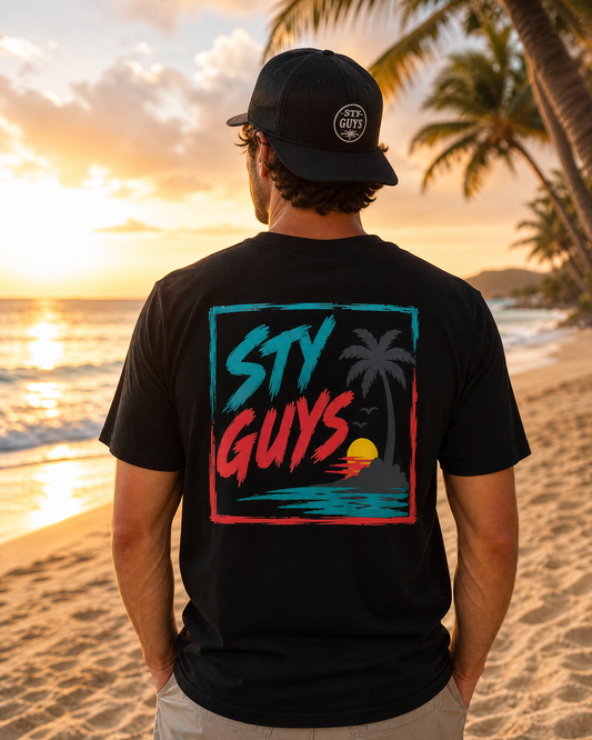 Man on the beach wearing the StyGuys Lone Palm tee with a minimal palm frame design
