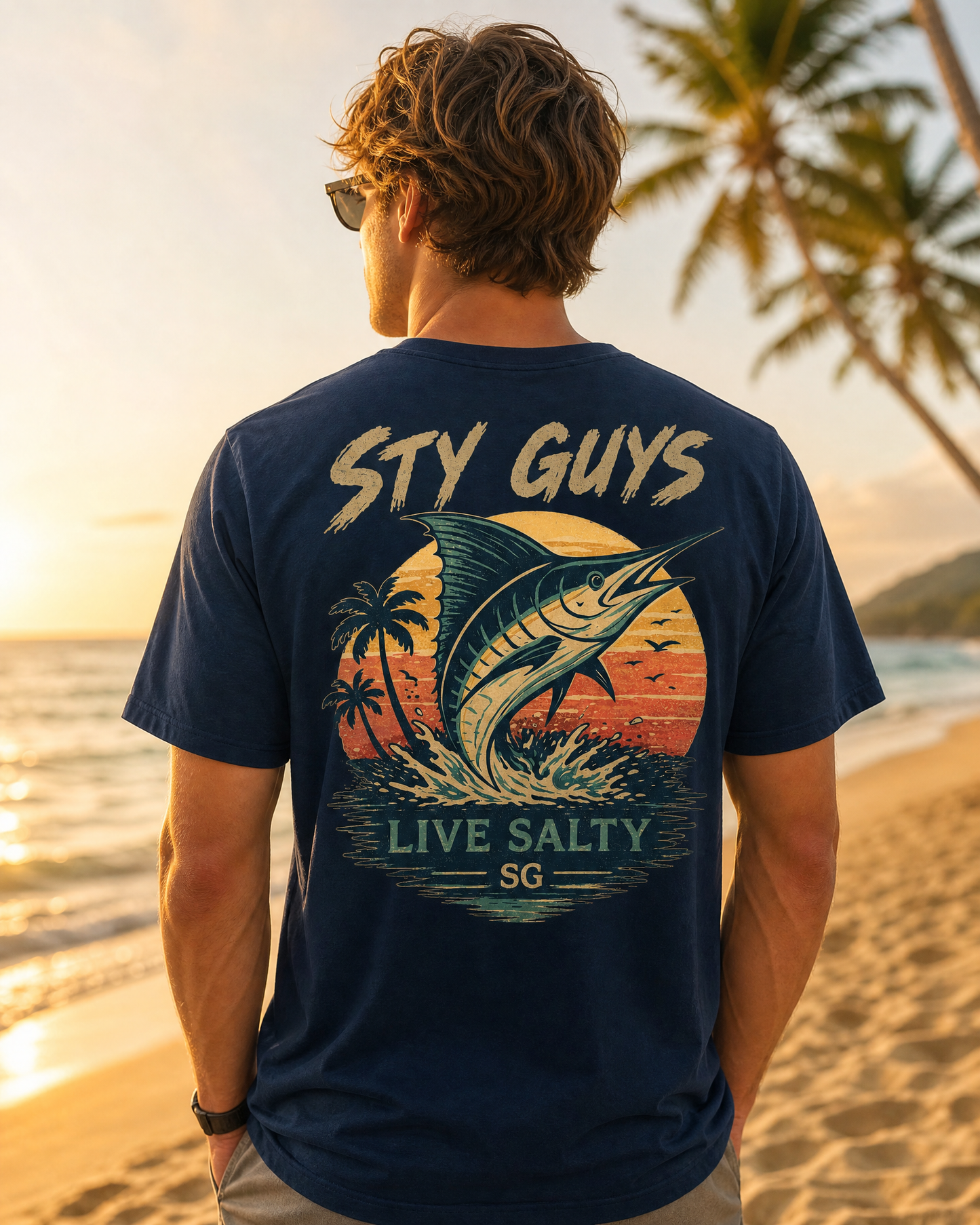 Man wearing the Live Salty tee, Beach colorway, with a leaping marlin back print