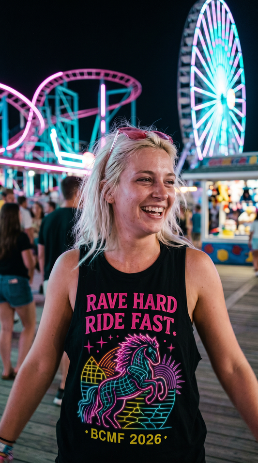 Woman wearing Rave Hard Ride Fast black tank under neon boardwalk lights at night
