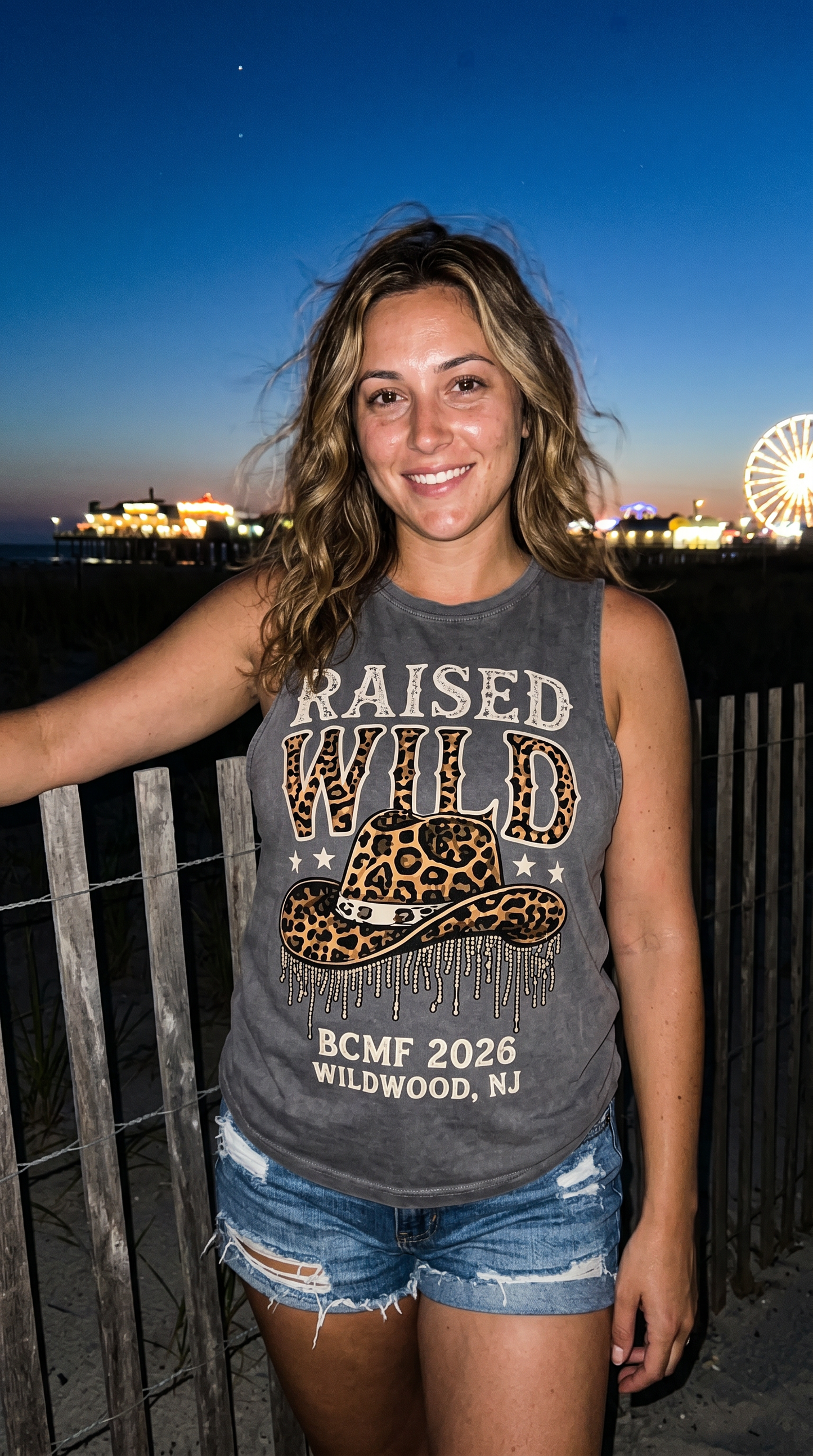 Woman wearing Raised Wild pepper tank on the beach at dusk with boardwalk lights