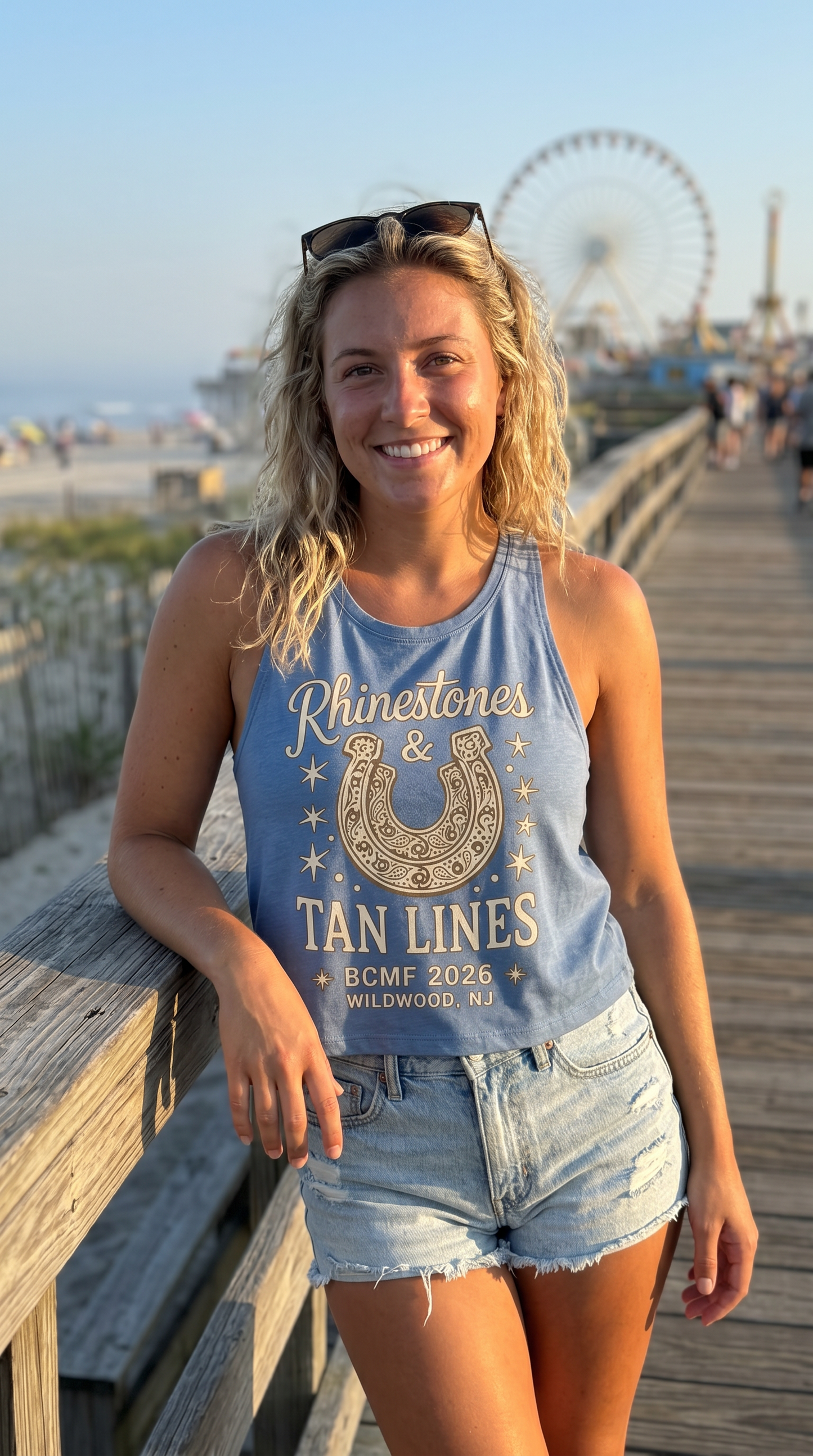 Blonde woman wearing the corrected Rhinestones & Tan Lines chambray tank on the Wildwood boardwalk at golden hour