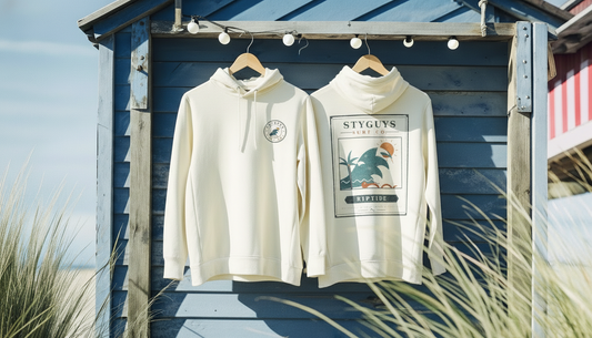 StyGuys Surf Co Riptide hoodies in cream showing chest logo and vintage surf poster back print